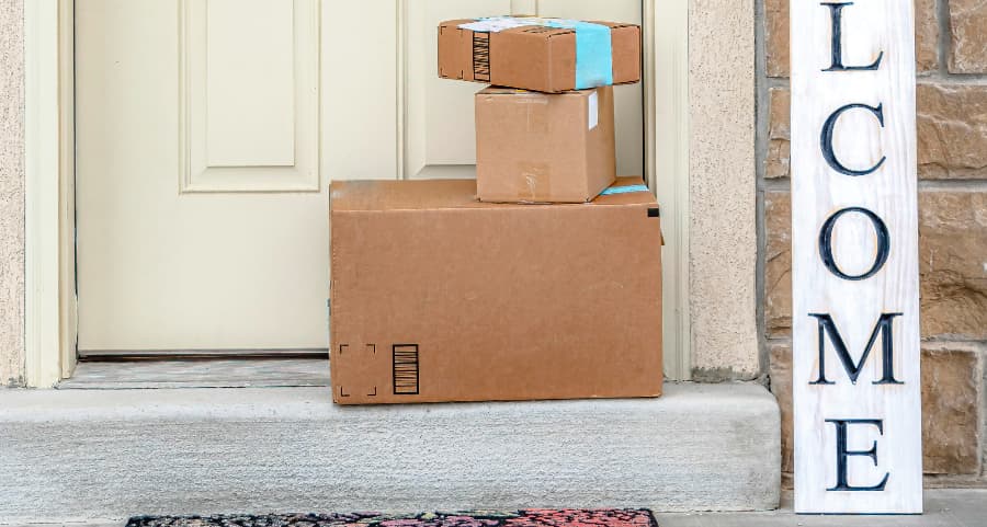 Deliveries on the front porch of a house with a welcome sign in Florence